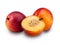 Two ripe nectarine fruits and one cut in half