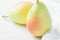 Two Ripe Organic Pears in Pastel Green Yellow Red Colors on White Wood and Linen Fabric. Elegant Minimalist Japanese Style