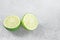Two ripe slices of green lime citrus fruit
