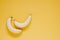 Two ripe sweet testy bananas on yellow background top view with