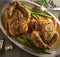 Two roasted whole chickens with asparagus top view