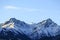 Two rocky snow-capped peaks of the Trans-Ili Alatau mountains in clear weather in the early autumn morning.