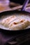 Two rolled cheese doughnuts in frying pan