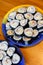 Two round plates of homemade sushi maki with salmon, rice and avocado