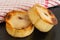 Two Round Scotch Pies on Black Slate Serving Tray with Red Checked Teatowel