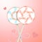 Two round striped pastel pink and blue color lollipops with decorative ribbon and blurred hearts. Couple candies on