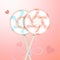 Two round striped pastel pink and blue color lollipops with decorative ribbon and blurred hearts. Couple candies on