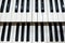 Two rows of black and white keys of an old musical instrument, an organ
