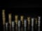 Two rows of coin stacks. Silver and gold coin stacks isolated on dark background