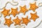 Two rows of eight decorative golden stars handmade from dough