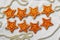 Two rows of eight decorative golden stars handmade from dough