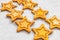 Two rows of eight decorative golden stars handmade from dough