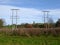 Two Rows of Electricity Pylons Reaching into the Distance