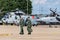 Two Royal Air Force Pilots walking across the tarmac at RAF Waddington with aircraft sitting in the background.