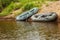 Two rubber boats lie on the sandy shore