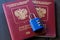 Two Russian passports on lock. Blue padlock with combination. Wooden background