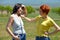 Two Russian women talking with each other and sincerely laughing with teeth.