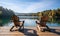 Two Rustic Wooden Chairs on a Serene Lakefront Dock