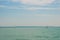 Two sailing boats on foreground under beautiful blue sky with clouds. Yachting competition on Lake Balaton, Hungary.