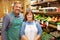 Two Sales Assistant At Vegetable Counter Of Farm Shop