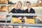 Two salesladies at the cheese counter offering their goods