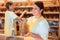 Two salesladies selling bread and other products in bakery shop