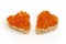 Two sandwich in the form of a heart with red caviar white