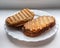 Two sandwiches of coarse grain bread for a quick bite lie on a white plate