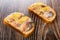 Two sandwiches with mackerel, lemon on wooden table