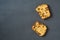 Two scattered pieces of tasty sweet homemade bread with raisin lies on dark concrete table on kitchen