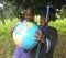 Two school children studying world globe map outdoors