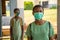 Two school kids wearing face masks and observing physical distancing