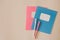 Two school notebooks and bright colored pen