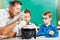 Two schoolboys and their teacher in class