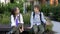 Two schoolchildren are sitting on a bench in the schoolyard. The boys are talking animatedly. School friendship.