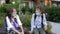 Two schoolchildren are sitting on a bench and are talking animatedly. Boys took off their boring medical masks.School