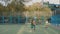 Two schoolchildren throw a ball in a basketball basket of a school playground