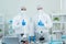 Two scientists wearing personal protective and safety glass standing and thumb up in the laboratory. Research on the coronavirus