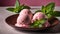 Two scoops of pink ice cream with mint leaves