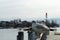 Two seagulls in lateral view standing on metal railing on the pier or in harbor with Lake Zurich in Switzerland.