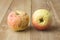 Two sear apple on wood background