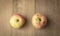 Two sear apple on wood background