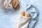 Two seeded chiabattas and slices of bread in a zero waste cotton bag on a beautiful, clean, rustic, blue background