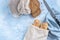 Two seeded chiabattas and slices of bread in a zero waste cotton bag on a beautiful, clean, rustic, blue background with a bread k