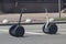 Two segways stand on a city street