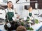 Two sellers in fish section of supermarket