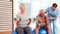 Two senior citizens exercising with physiotherapist