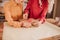 Two senior good-looking ladies in bright clothes standing near the table