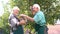 Two senior people picking apples.