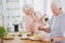 Two seniors talking during breakfast